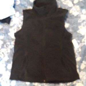 Black Sleeveless Turtleneck fleece vest.